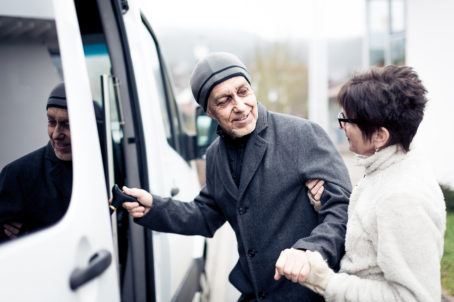 Nurse helping senior man enter a van in Laguna Hills, California