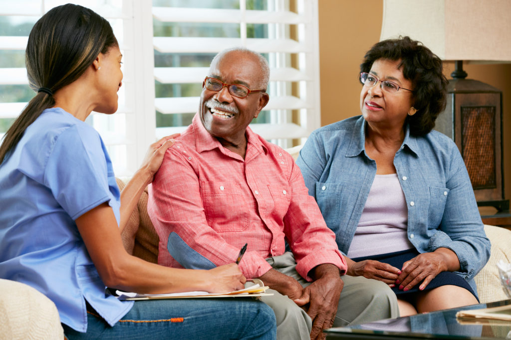 Nurse Making Notes During Home Visit With Senior Couple in Laguna Hills, CA.