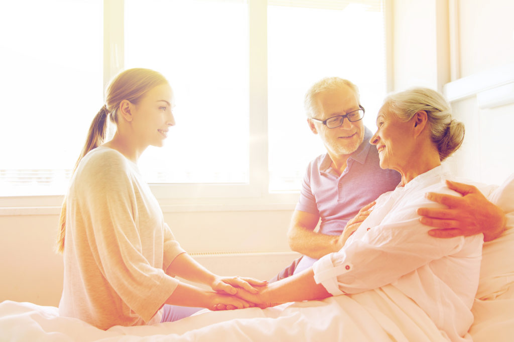 Woman sitting with senior man and woman in Laguna Hills, California.