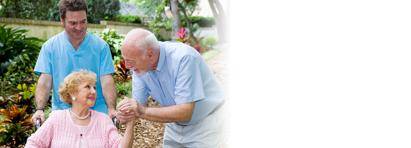 Caregiver helps woman through garden in Laguna Hills, CA.